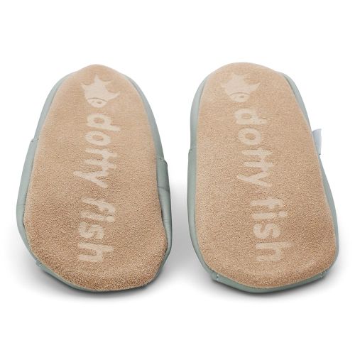 Soft suede non-slip sole of Dotty Fish infant shoes imprinted with Dotty Fish name and logo.