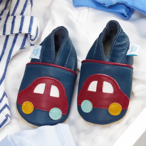 Navy leather shoes with car design, in drawer with baby clothes.