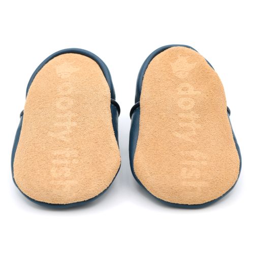 Non-slip soft suede soles of Dotty Fish pre-walker shoes imprinted with Dotty Fish name and logo.