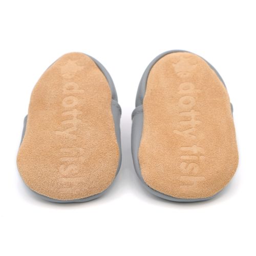 Soft suede non-slip sole of Dotty Fish infant shoes imprinted with Dotty Fish name and logo.