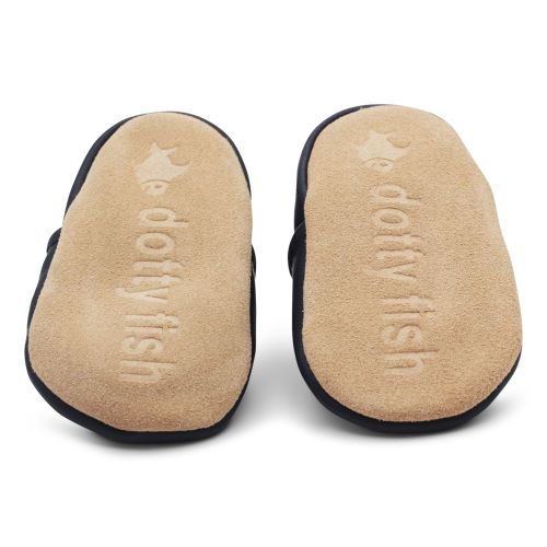 Soft suede non-slip sole of Dotty Fish infant shoes imprinted with Dotty Fish name and logo.