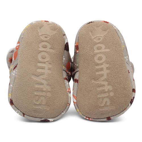 Non-slip suede sole of baby booties, imprinted with Dotty Fish logo.