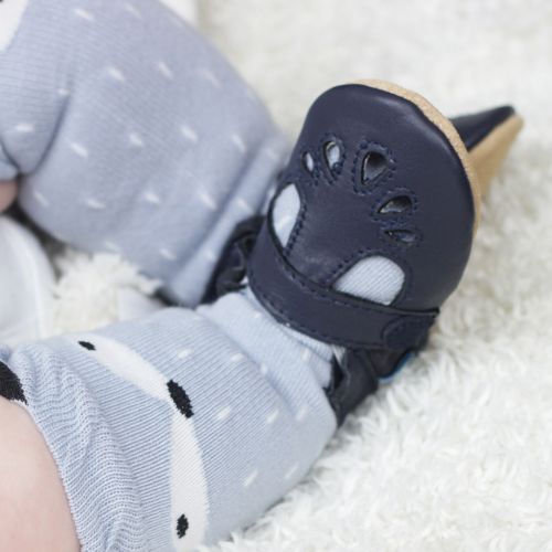 Toddler wearing navy leather Dotty Fish baby and toddler girl’s soft sole T-bar shoes.