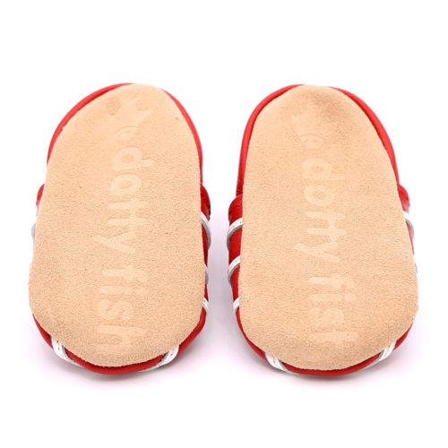 Soft suede non-slip sole of Dotty Fish infant shoes imprinted with Dotty Fish name and logo.