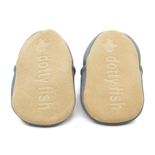 Non-slip soft suede soles of Dotty Fish pre-walker shoes imprinted with Dotty Fish name and logo.