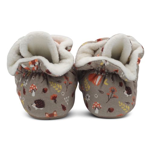Back of light brown baby booties with woodland design.