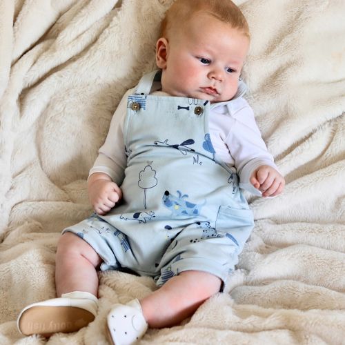Baby wearing Dotty Fish white star leather shoes.