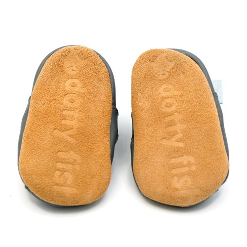 Soft suede non-slip sole of Dotty Fish infant shoes imprinted with Dotty Fish name and logo.