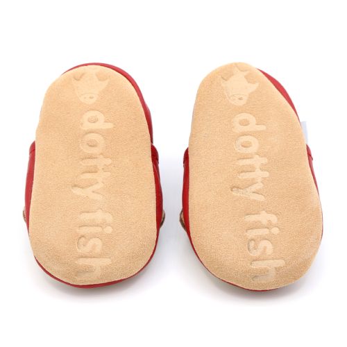 Soft suede non-slip sole of Dotty Fish infant shoes imprinted with Dotty Fish name and logo.
