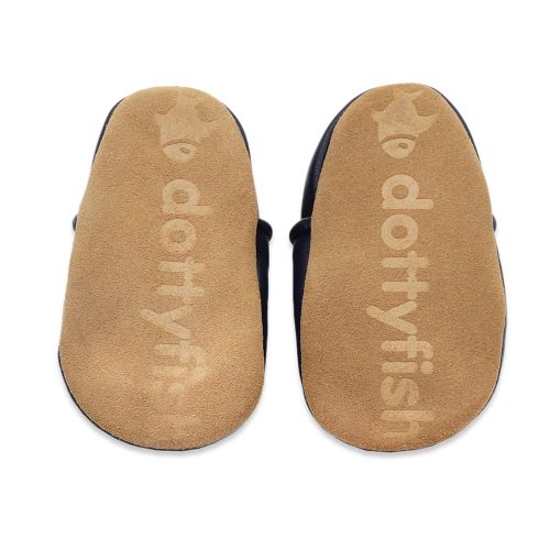 Soft suede non-slip sole of Dotty Fish infant shoes imprinted with Dotty Fish name and logo.