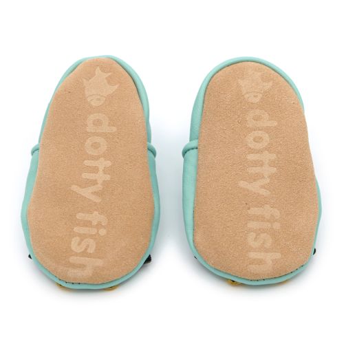 Non-slip soft suede soles of Dotty Fish pre-walker shoes imprinted with Dotty Fish name and logo.