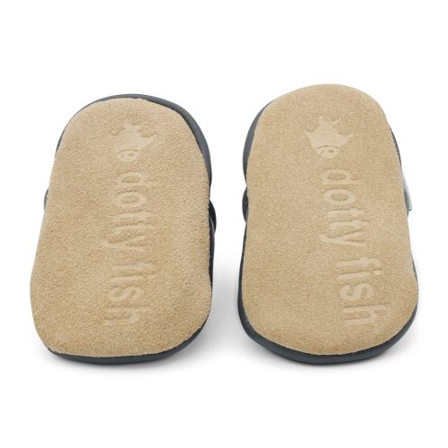 Non-slip soft suede soles of Dotty Fish pre-walker shoes imprinted with Dotty Fish name and logo.
