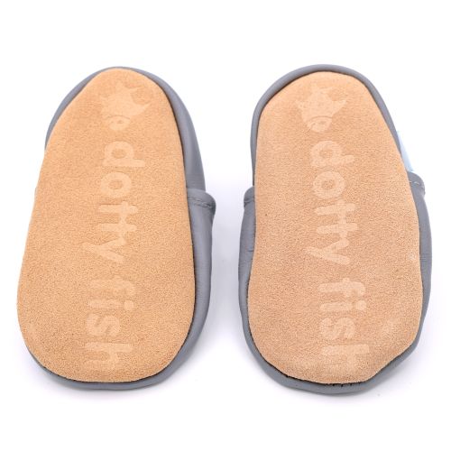 Non-slip soft suede soles of Dotty Fish pre-walker shoes imprinted with Dotty Fish name and logo.