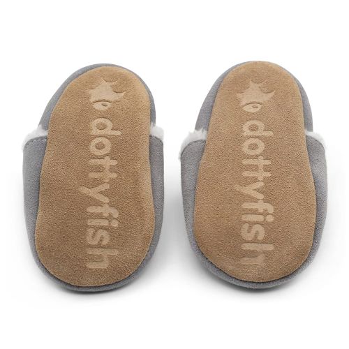 Non-slip soft suede soles of Dotty Fish children’s slippers imprinted with Dotty Fish name and logo.
