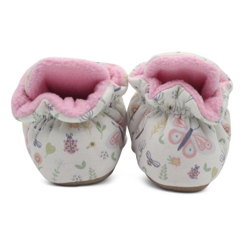 Back of cream cotton baby booties, with pink fleece lining.