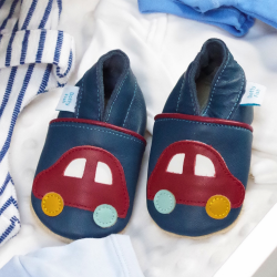 Navy leather shoes with car design, in drawer with baby clothes.