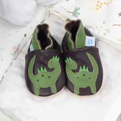 Leather dinosaur shoes with baby blankets.